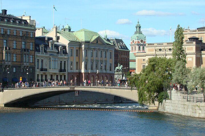 Scenic waterfront walking path along Stockholm harbour with city skyline visible